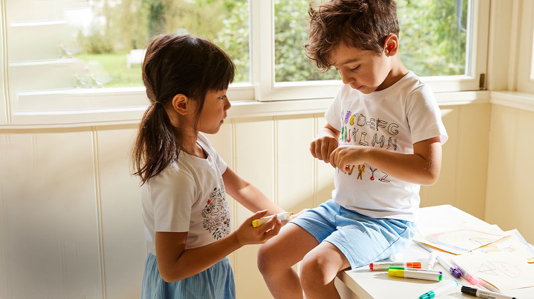 Mädchen und Junge in Ausmalshirts aus Bio-Baumwolle